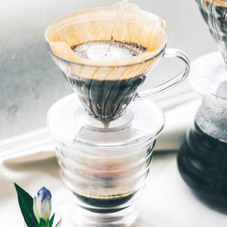 HARIO V60-01 (100 Pack) paper filter brewing fresh coffee in glass dripper set with clear design