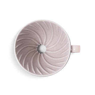 HARIO V60-02 Ceramic Dripper in soft pink porcelain with spiral ridges and central hole viewed from above