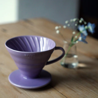 HARIO V60-02 Ceramic Dripper in purple porcelain with spiral ribbed design on wooden table