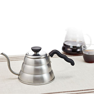 HARIO Buono Kettle 1000ml stainless steel with black ergonomic handle and gooseneck spout on cloth surface
