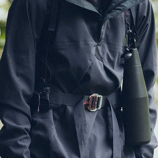 KINTO TRAIL Tumbler 1080ml in olive green stainless steel, clipped to a black outdoor jacket belt loop