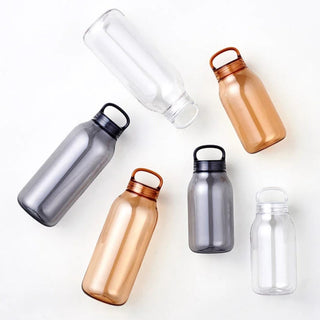 KINTO WATER Bottle 300ml in transparent, amber, and smoky colors with silicone loop lids shown from above