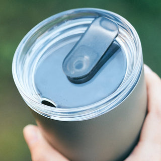 KINTO To Go Tumbler (with plug) 360ml close-up of clear lid and black silicone plug detail in hand