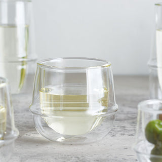 KINTO KRONOS Double Wall Wine Glass 250ml with clear heat-resistant glass holding white wine on stone surface