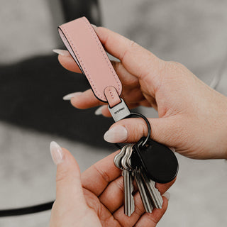 Orbitkey Loop Keychain in pink Nappa leather held with attached keys and key fob in hands