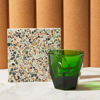 notNeutral VERO Cappuccino Glass 6oz in transparent green glass with faceted texture on marble surface