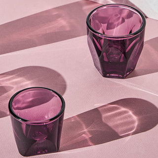 notNeutral VERO Espresso Glass 3oz in deep purple with faceted glassware casting shadows on pink surface