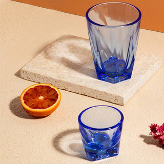 notNeutral VERO Espresso Glass 3oz set in vibrant blue glass with textured reflections on stone surface