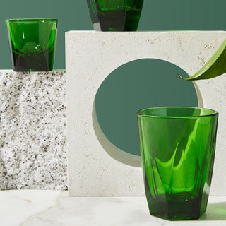notNeutral VERO Latte Glass 12oz in green glass shown with geometric stone props and leaf detail