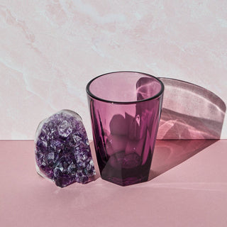notNeutral VERO Latte Glass 12oz in purple glass beside a purple crystal on pink surface with shadow