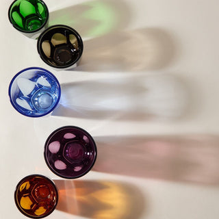 notNeutral VERO Latte Glass 12oz in various colors casting long colorful shadows on white surface