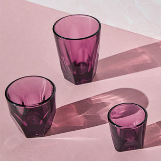 notNeutral VERO Latte Glass 12oz shown in purple glassware with faceted texture on pink surface