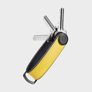 Orbitkey Key Organizer Hybrid Leather in black and yellow holding multiple metal keys fanned out