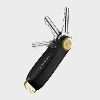 Orbitkey Saffiano Leather Key Organiser in black with gold hardware holding multiple keys compactly