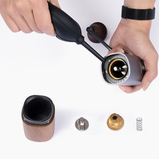 Timemore Air Blower cleaning inside a disassembled electric coffee grinder with silicone bulb in use