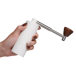 Timemore Chestnut Nano 3 Grinder held in hand showing white aluminum body and walnut handle detail