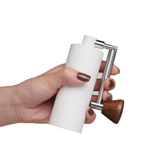Timemore Chestnut Nano 3 Grinder held in hand showing white aluminum body and wooden handle detail