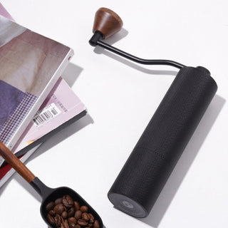 Timemore Chestnut Slim 3 Grinder with textured black aluminum body and walnut handle detail on white surface