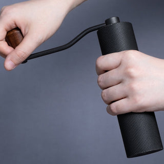 Timemore Chestnut Slim 3 Grinder with black textured aluminum body and walnut handle in hand grip motion