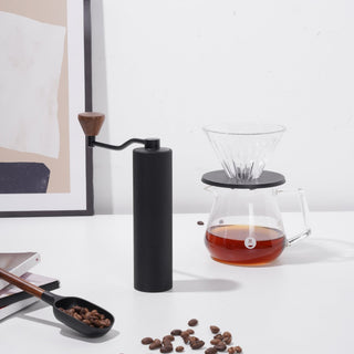 Timemore Chestnut Slim 3 Grinder in black aluminum with walnut handle next to coffee brewing setup