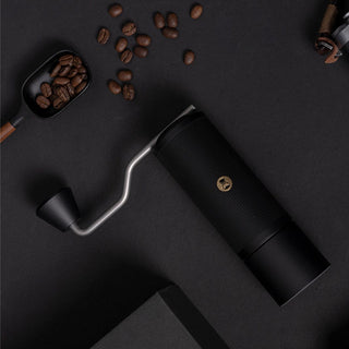 Timemore Chestnut X Lite black stainless steel manual coffee grinder with silver handle on dark background