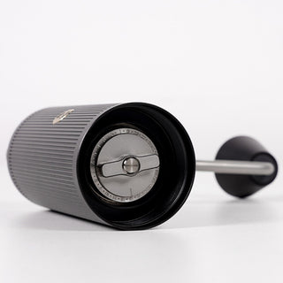 Timemore Chestnut X Lite hand grinder with stainless steel burrs and textured black body angled view