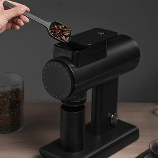 TIMEMORE Sculptor 078 Brew Grinder (120V) black aluminum alloy body with coffee beans being added