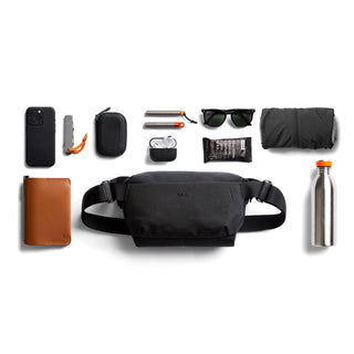Bellroy Venture Sling 6L in black recycled nylon shown with everyday carry items around it