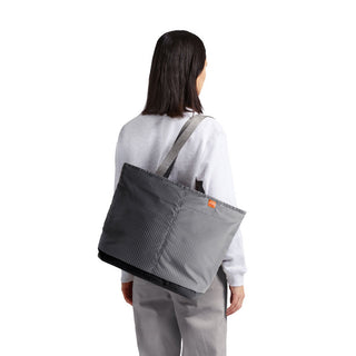 Bellroy Lite Cooler Tote 16L in grey recycled fabric worn over shoulder by person facing away