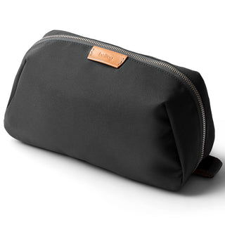Bellroy Toiletry Kit Plus in black recycled fabric with leather zipper pull and compact design