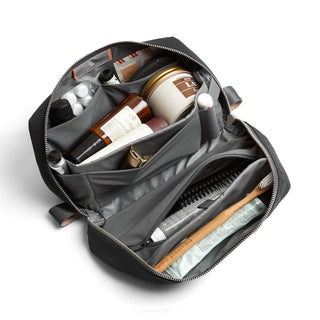 Bellroy Toiletry Kit Plus open showing organized compartments with travel-sized bottles and personal care items