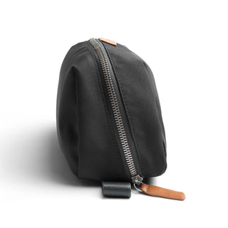 Bellroy Toiletry Kit Plus in black recycled fabric with durable metal zipper and leather pull tab side view