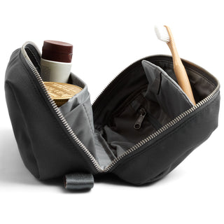 Bellroy Toiletry Kit Plus black woven fabric with multiple compartments and travel essentials inside